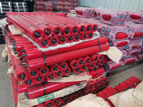 Red painted conveyor rollers for belt conveyor system