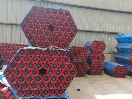 Red painted conveyor rollers for belt conveyor system