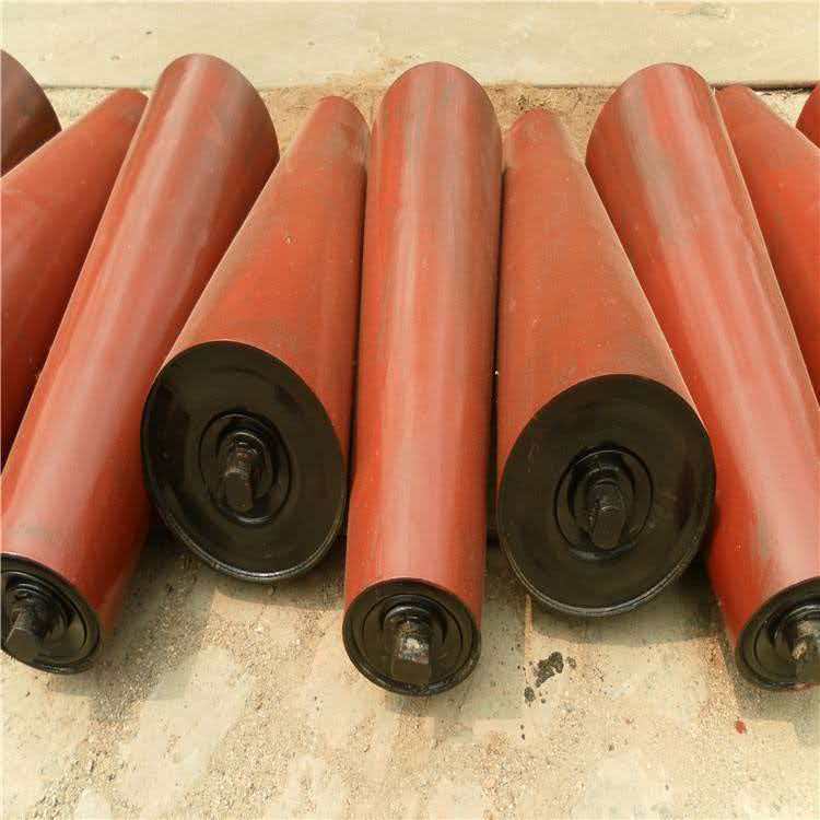 Red tapered idler rollers for conveyor belt alignment