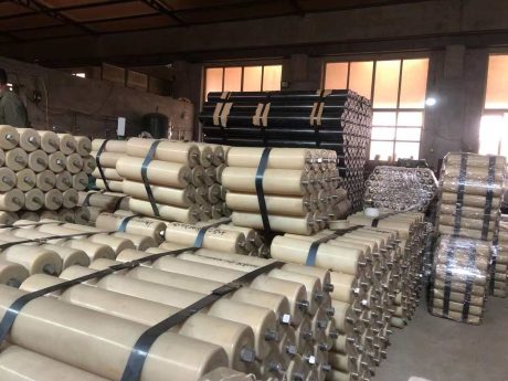 Nylon rollers stacked in factory warehouse