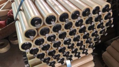 Close-up of nylon conveyor rollers with shafts